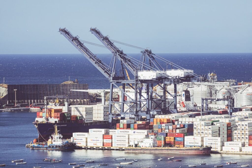 Busy container shipping port in Santa Marta, Colombia, showcasing cranes and cargo ships.